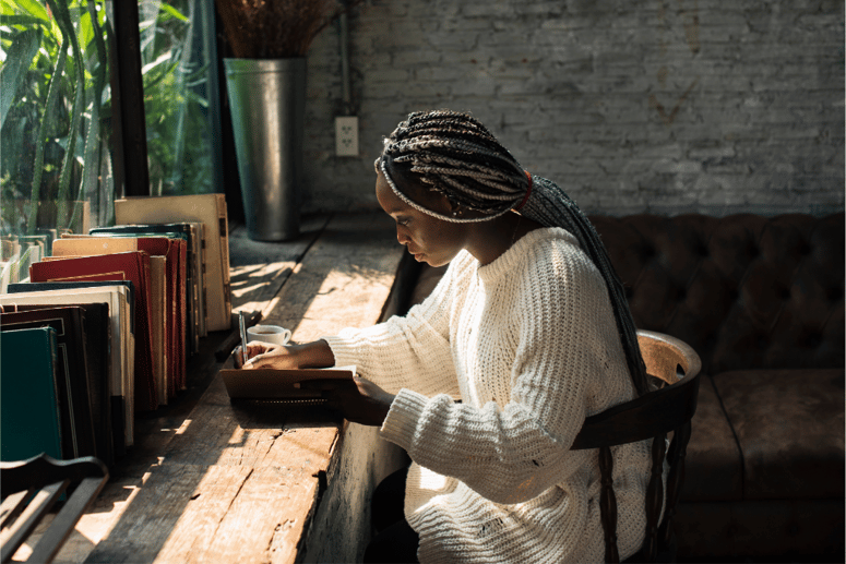 Stock Image - Woman Writing at a Window