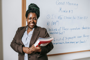 Teacher standing in front of white board