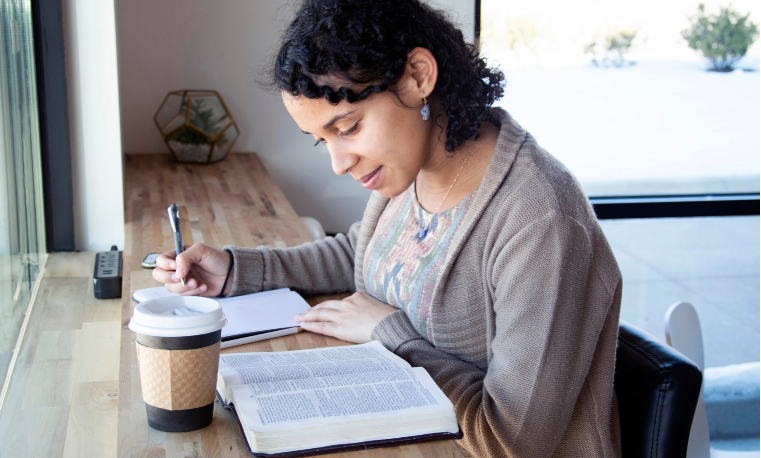 Woman taking bible notes